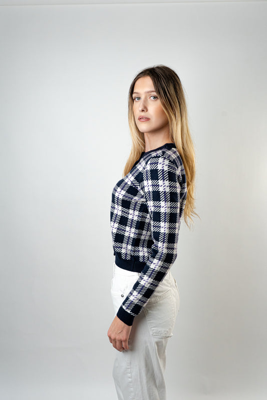 "Side view of model wearing the Blair Knit Cardigan in a navy and white checkered pattern.