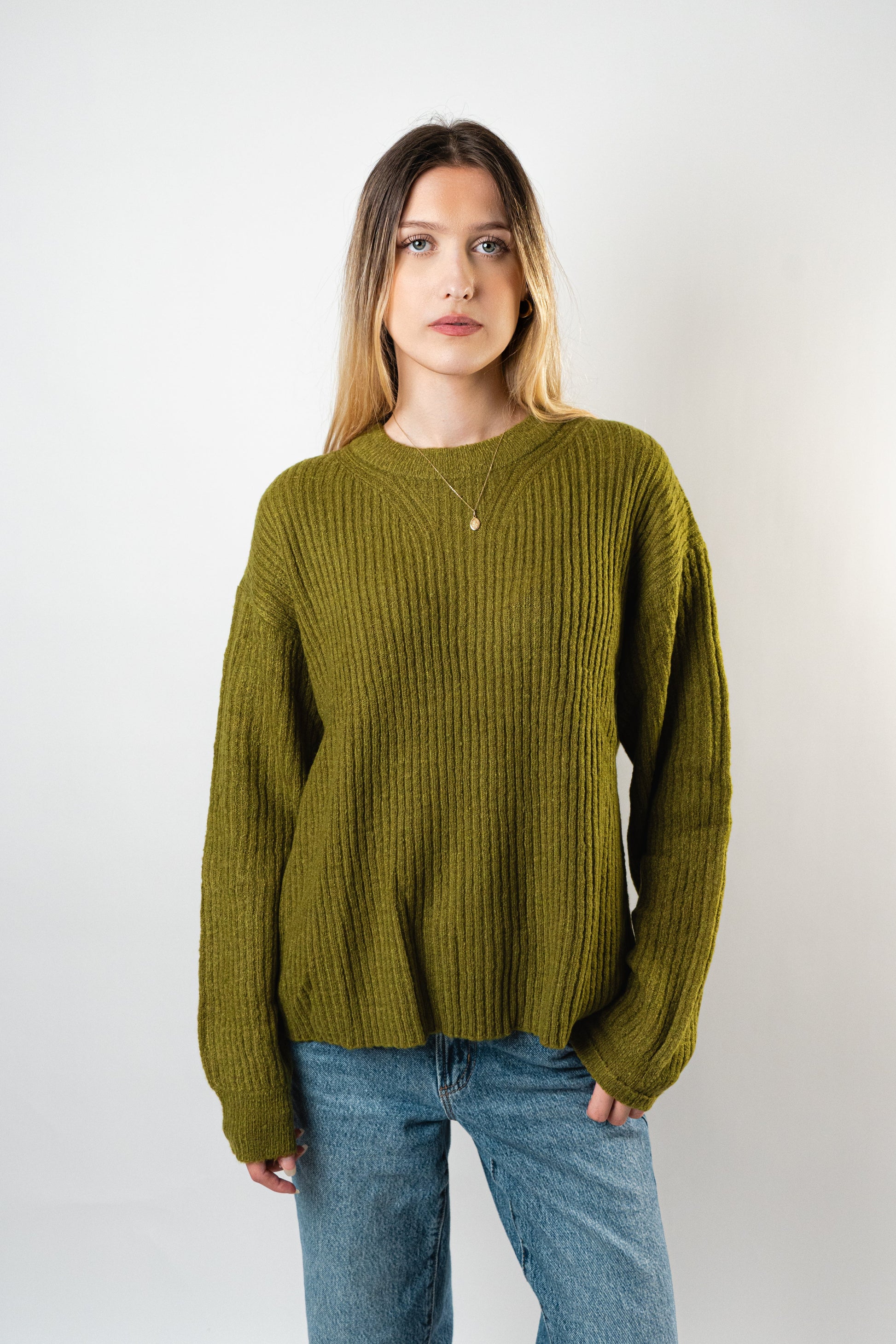 Model wearing the Betty Cooper Ribbed Sweater in olive green.